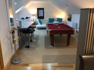 a living room with a pool table and a couch at Luxury Studio Loft with Car Charging Point in Frizington +15 photos