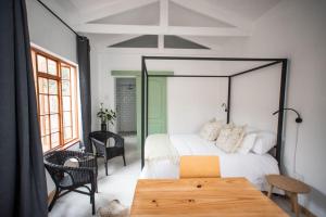 a bedroom with a large bed and a wooden table at Parmant in Robertson