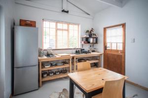 a kitchen with a wooden table and a refrigerator at Parmant in Robertson +7 photos
