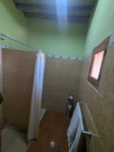 a bathroom with a shower with a shower curtain at Kasbah Ait ben Damiette in Skoura +24 photos