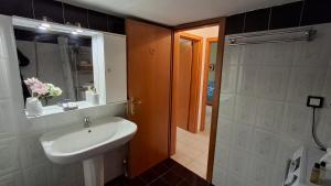a bathroom with a sink and a mirror and a shower at SweetHome Komotini central & comfy apartment with Parking in Komotini +29 photos