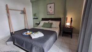 a bedroom with a bed with a tray of food on it at SweetHome Komotini central & comfy apartment with Parking in Komotini