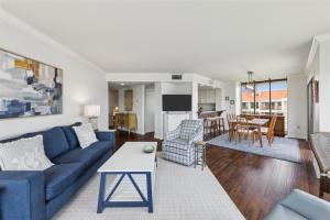 a living room with a blue couch and a table at 261 Captains Quarters in Hilton Head Island