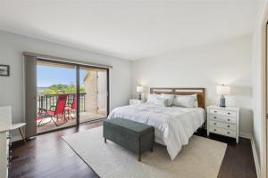 a bedroom with a large bed and a balcony at 261 Captains Quarters in Hilton Head Island +40 photos