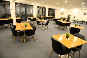 a dining room with tables and chairs and tablesktop at Hotel zur Flüh in Bad Säckingen