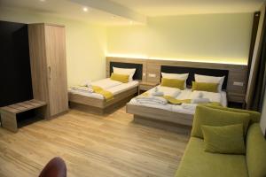 a hotel room with two beds and a couch at Hotel zur Flüh in Bad Säckingen