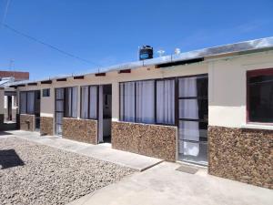 an empty building with windows on the side of it at Cabaña Sal y Piedra in Uyuni