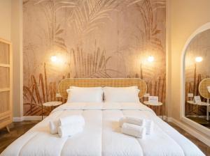a bedroom with a large white bed with two pillows at Sfazion - Central Apartment in Bari