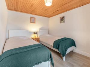 a bedroom with two beds and a wooden ceiling at 3 Bed in Roundstone oc-i234 in Callow