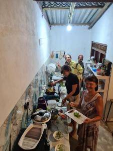 a group of people standing in a kitchen preparing food at Duncan Murray Villa in Hambantota