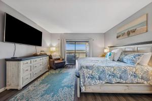 a bedroom with a bed and a flat screen tv at 201 Captains Quarters in Hilton Head Island +42 photos