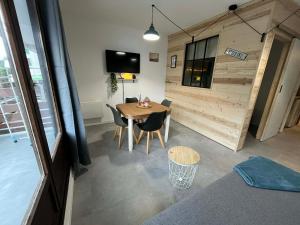 a room with a table and chairs in a room at L'ourson B2 in La Bresse