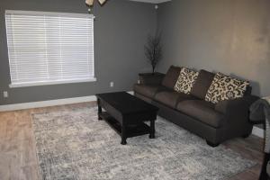 a living room with a couch and a table at The Duplex in Lubbock