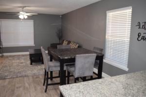 a dining room with a table and chairs and a couch at The Duplex in Lubbock