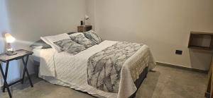a bedroom with a bed with a white comforter and pillows at Hospedaje Solymar Sarie Bay in San Andrés
