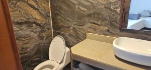 a bathroom with a sink and a toilet and a mirror at Hospedaje Solymar Sarie Bay in San Andrés +27 photos