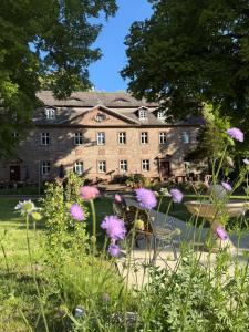 a large stone building with flowers in the foreground at Schloss Zingst in Zingst