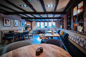 a restaurant with tables and chairs in a room at The Old Bridge Inn, Holmfirth, West Yorkshire - The Coaching Inn Group in Holmfirth