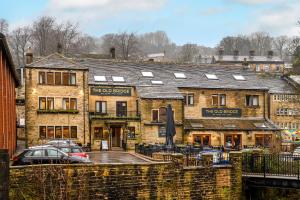a building with a car parked in front of it at The Old Bridge Inn, Holmfirth, West Yorkshire - The Coaching Inn Group in Holmfirth