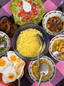 a table topped with bowls of eggs and other food at Chara Bloom Hotel in Dickwella