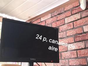 a computer monitor in front of a brick wall at Amor amor in San Luis