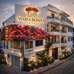 a hotel margarita with red flowers on the facade at Hotel Maria Bonita Higüey in Higuey
