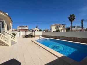 a swimming pool in front of a house at Casa Noel in Ciudad Quesada