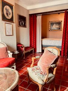 a living room with a bed and a table and chairs at La Clé de la Porte Rentals in Antibes
