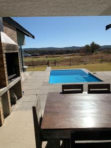 a swimming pool on a patio with a wooden table at Spot the 10th in Parys
