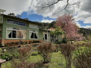 a green house with a garden in front of it at BTR Farm in Da Ðeum (2)