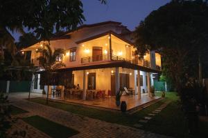 a large house at night with a patio at Yala Lemon View in Tissamaharama