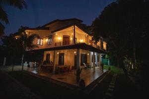 a large house at night with lights at Yala Lemon View in Tissamaharama