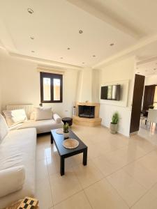 a living room with a couch and a table at Villa Fanouris in Chania
