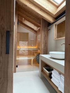 a bathroom with a white sink and wooden ceilings at Al Crotto in Chiavenna +48 photos