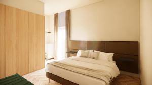 a bedroom with a large bed with a large headboard at Vivere Hotel in Catania