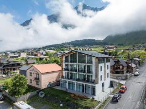 an aerial view of a city with a mountain at 3100 Boutique Hotel Kazbegi in Kazbegi