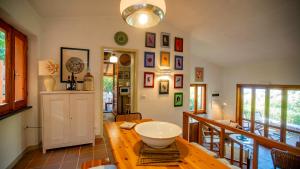 a room with a wooden table with a bowl on it at Villa Averla-Costa Paradiso, con giardino vista graniti e mare in Costa Paradiso +62 photos