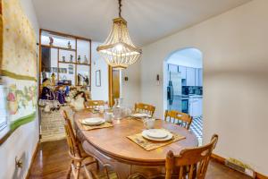 a dining room with a table and chairs and a chandelier at Pool Table & Shared Sauna! Potomac River Basecamp in Westernport