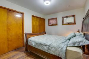 a bedroom with a bed and a wooden closet at Pool Table & Shared Sauna! Potomac River Basecamp in Westernport