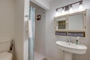 a white bathroom with a sink and a shower at Pool Table & Shared Sauna! Potomac River Basecamp in Westernport +20 photos