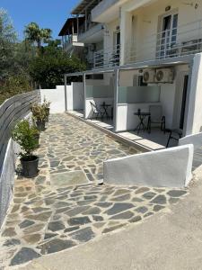 a building with a stone walkway in front of a building at Fiosal Apartments 2 in Skiathos