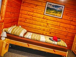a room with a bed in a log cabin at Penzión Hron - Beňuš in Beňuš
