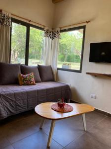 a living room with a couch and a table at Color Local Cabañas in San Javier