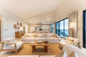 a living room with white furniture and a large window at 3075 - Paradise Cove 3A Cacalutilla in Tangolunda