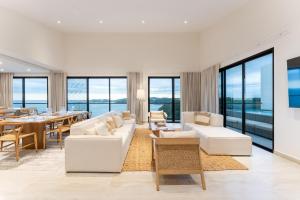 a living room with white furniture and a dining table at 3075 - Paradise Cove 3A Cacalutilla in Tangolunda