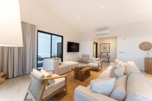 a living room with white furniture and a large window at 3075 - Paradise Cove 3A Cacalutilla in Tangolunda