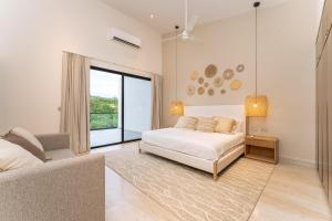 a bedroom with a bed and a large window at 3075 - Paradise Cove 3A Cacalutilla in Tangolunda +33 photos