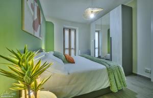 a bedroom with a large bed with green walls at Daniel House - Lake and ferry terminal 1 minute walk, in the heart of Bellano in Bellano