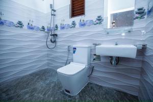 a bathroom with a toilet and a sink at Yala Lemon View in Tissamaharama