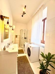 a bathroom with a washing machine and a sink at A casa di Maria in Sulmona +19 photos